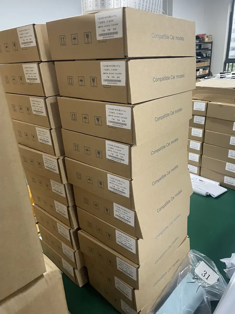 Printed master cartons for CarPlay decoder modules, labelled per compatible car model