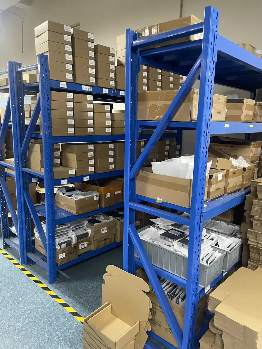Warehouse shelving holding packed CarPlay decoder modules ready for shipment