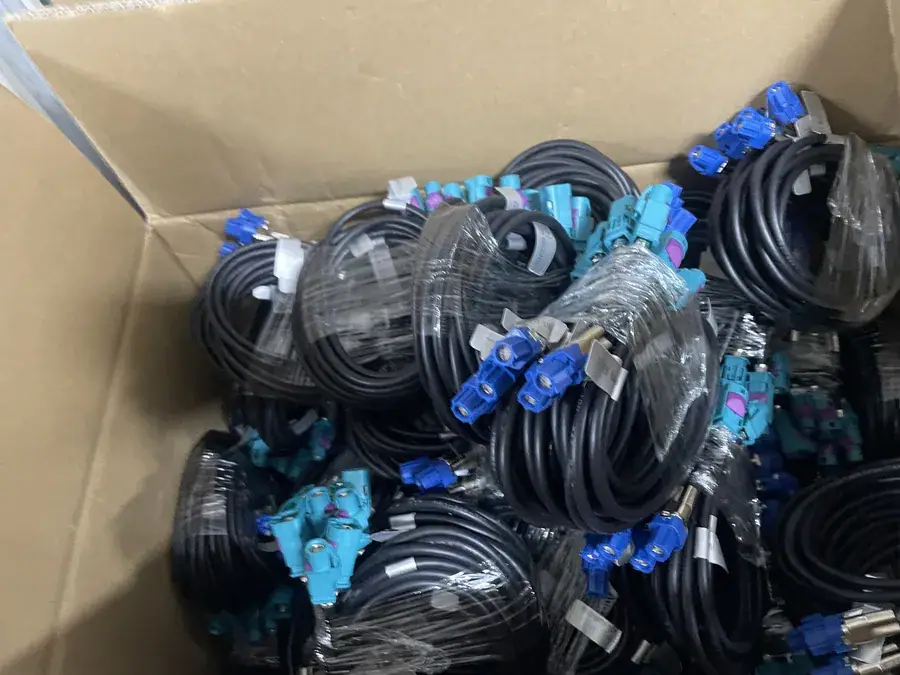 Wiring harness stock for CarPlay decoder modules, coiled and boxed before shipment